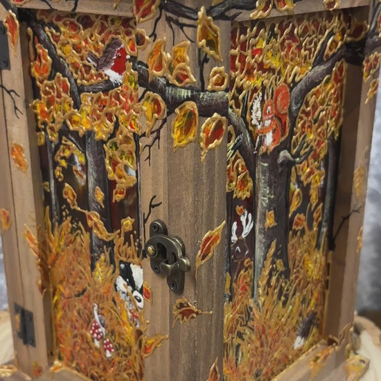 Wooden & Copper topped lantern handpainted with a autumnal woodland scene. Featuring Foxes, owl, Red squirrel, Badger, snail, Robin, Stag & hedgehog. With autumn foliage like acorns, mushrooms and fallen leaves